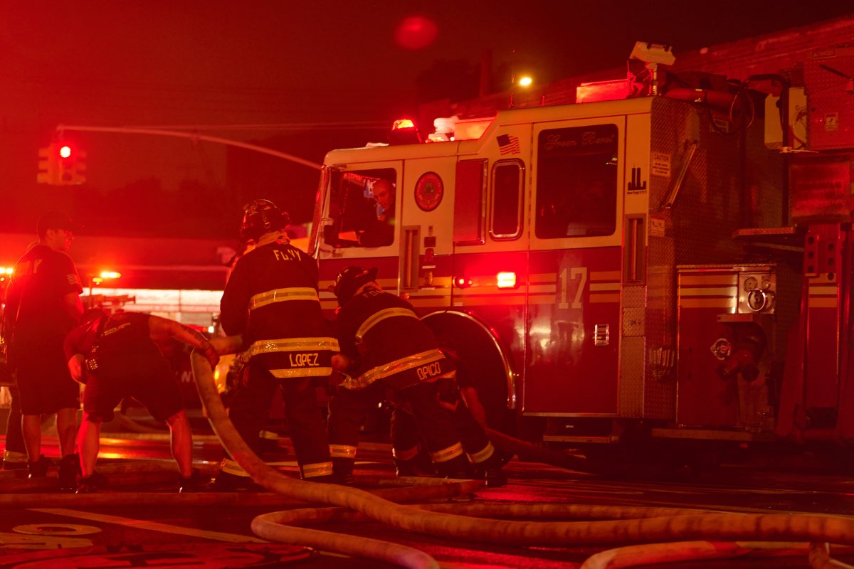 Firefighters work to move hoseline during a tense four alarm fire at 540 Tiffany Street.