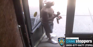 shirtless man entering a building. he is a suspect in a SoHo robbery