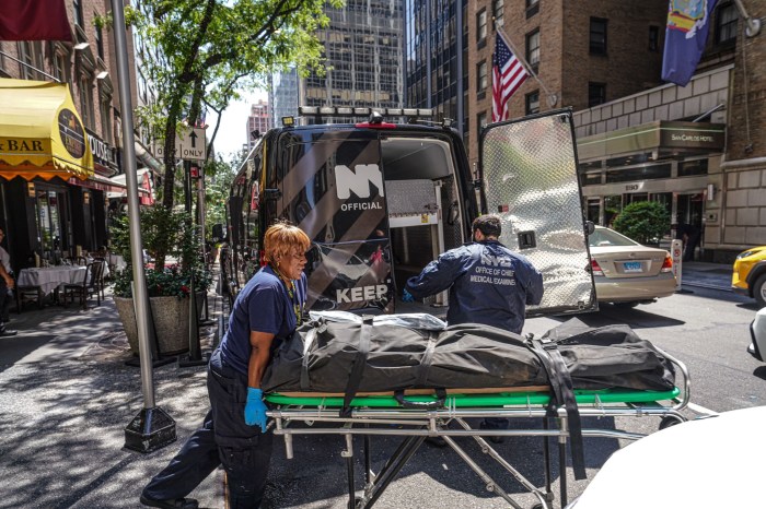 Medical Examiner's team transport body of man who leapt off Midtown hotel building
