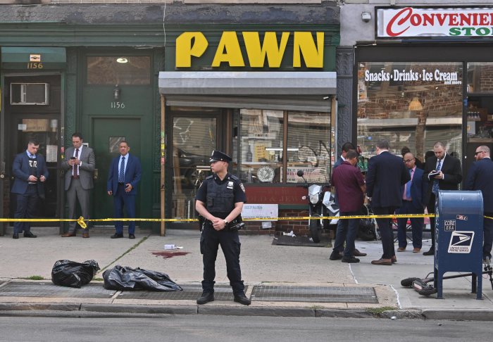 Brooklyn police officer stands guard outside shooting scene