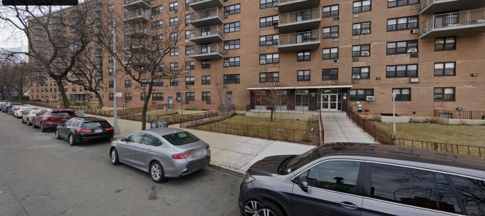 Bronx apartment building with car parked in front