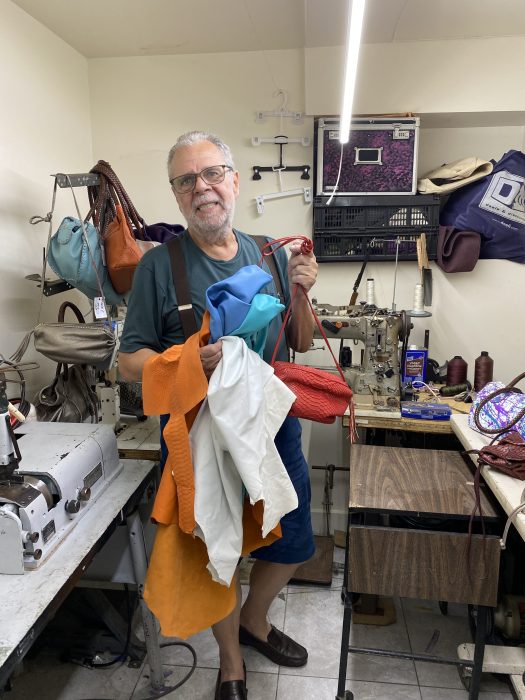 man holding up material in a design studio