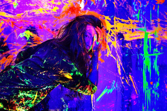 Kanami Kusajima, Washington Square Park artist, performing with colorful fluorescent paint