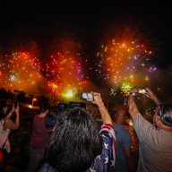 Spectators film the Macy's Fourth of July Fireworks Extravaganza