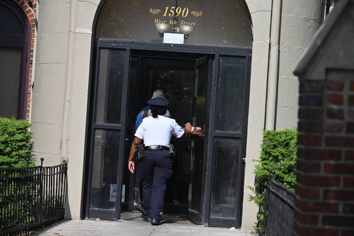 Officers entering the location where four people were found stabbed to death