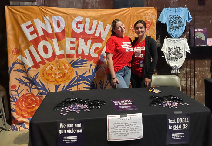 two teenagers at a table advocating for gun violence prevention