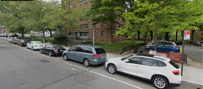 Sumner Houses in Brooklyn with cars parked out front