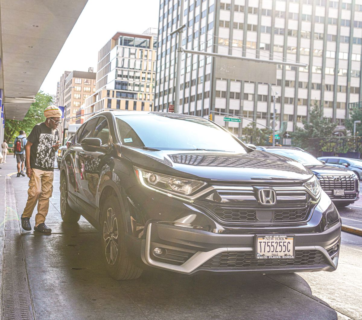 A customer picks up a ride-share vehicle in Manhattan