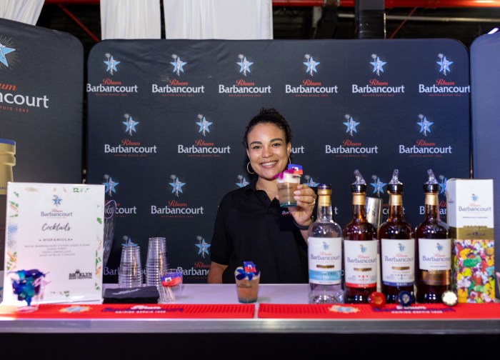 a person handing out rum at brooklyn rum fest