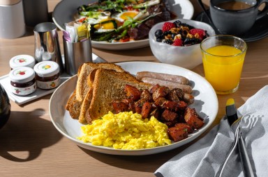 a classic breakfast of eggs, potatoes, and toast found at Point Seven