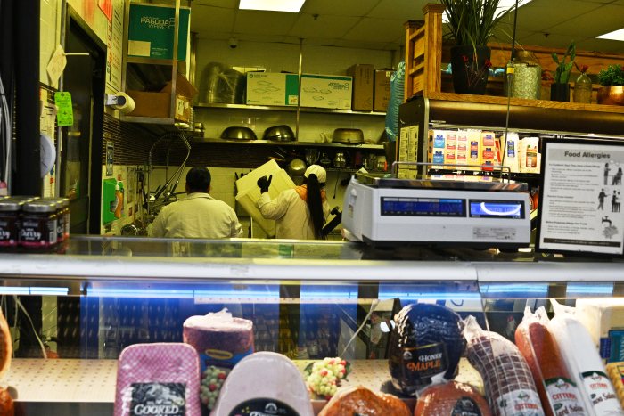 workers behind the counter of a deli