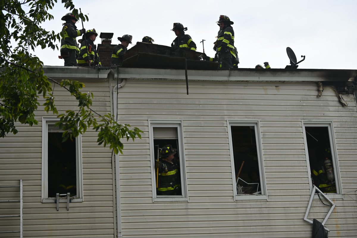 Firefighters operate in the rear during a three alarm fire at 80-16 80 Street.