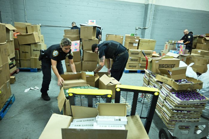 police going through boxes of illegal pot in Queens