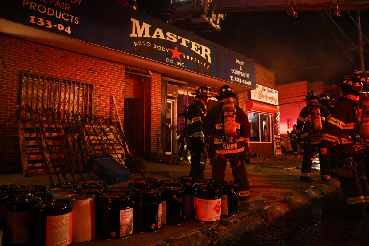 Queens firefighters battle major fire in auto repair shop and remove barrels of flammable material