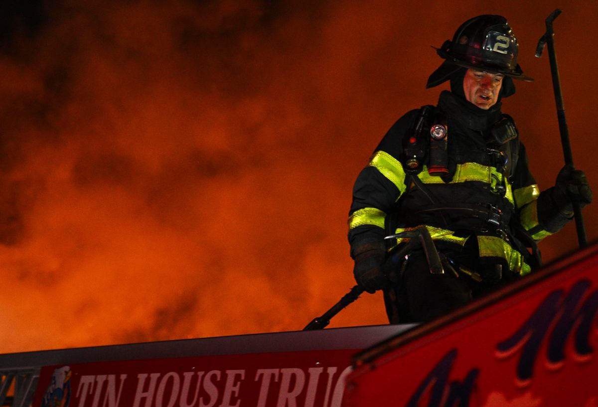 a fireman on a ladder fighting a fire