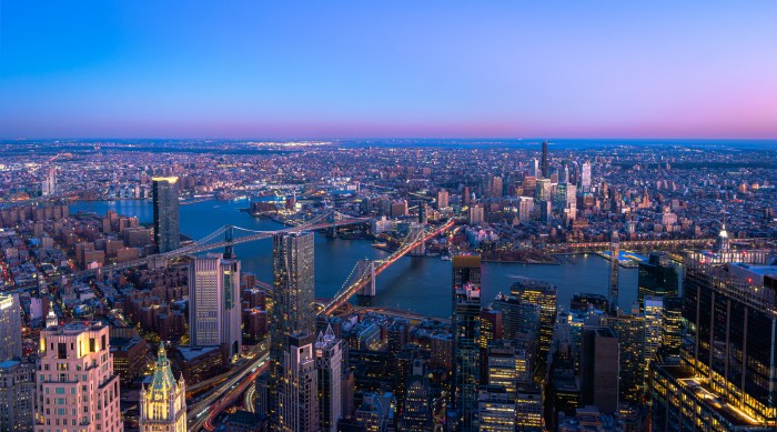 Skyline of Manhattan New York City during the night.View of Brooklyn and Manhattan Bridge over East River.