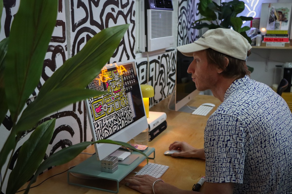 artist timothy goodman works on his computer