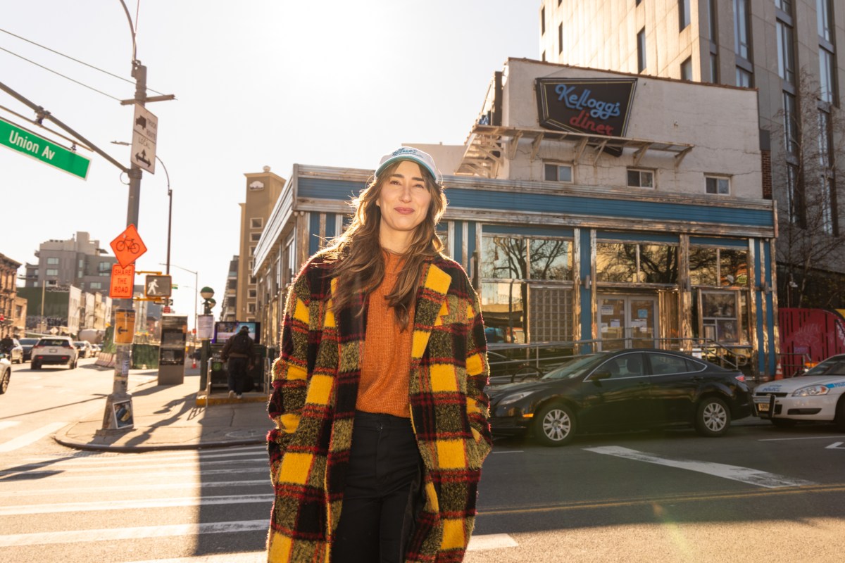 a woman standing outside of Kellogg's diner in Williamsburg