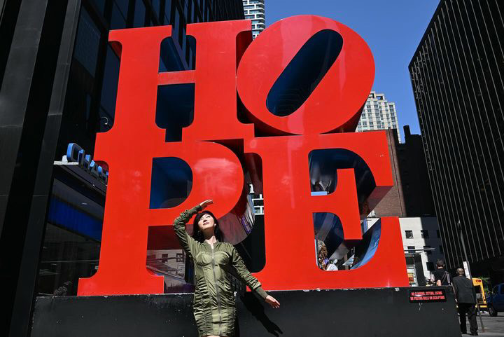 SAAY in front of the HOPE statue in NYC.