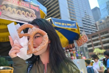 K-pop singer SAAY holding a pretzel in NYC.