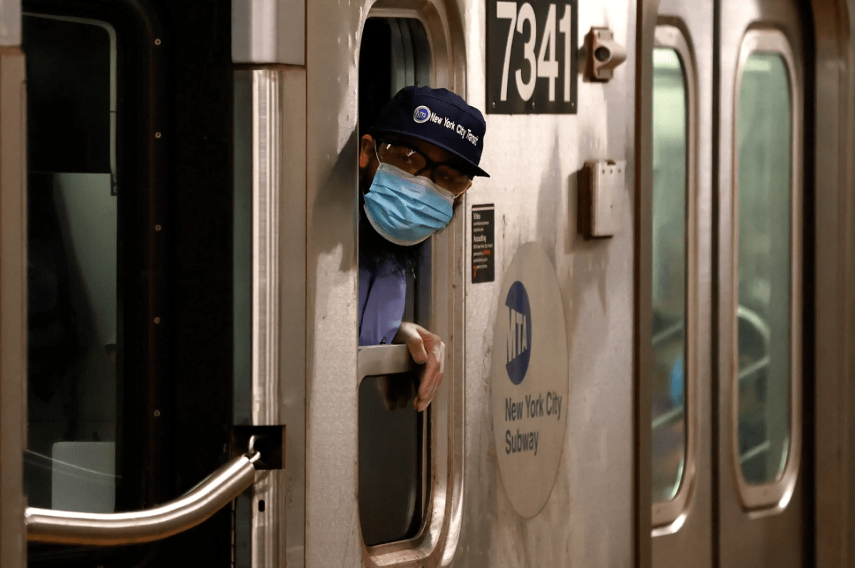 An MTA subway conductor peers out the cab window at the height of the COVID-19 pandemic in June 2020.