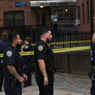 police in uniform by caution tape in Brooklyn