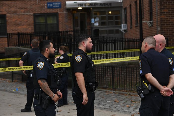 police in uniform by caution tape in Brooklyn