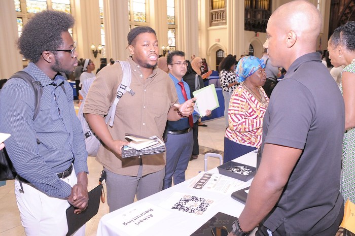 several people around a table at a nyc career fair