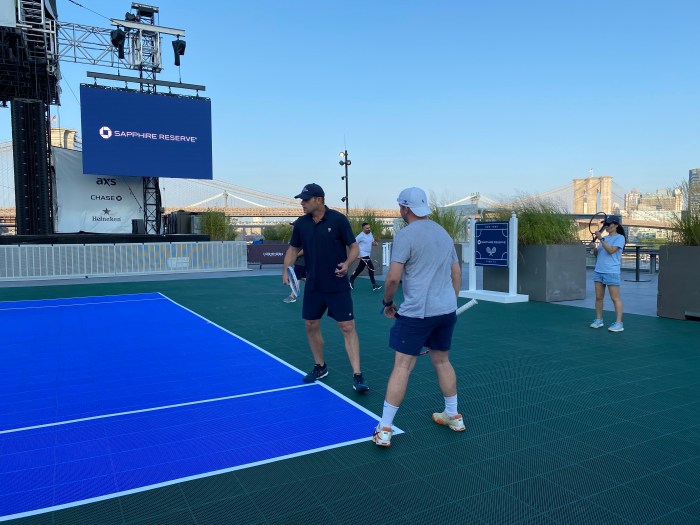 Andy Roddick with tennis players on a tennis court at the seaport in Lower Manhattan