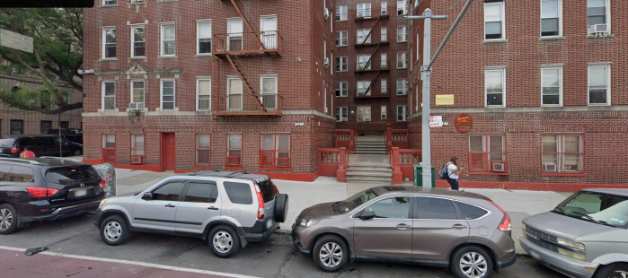 apartment building with cars parked in front in the Bronx