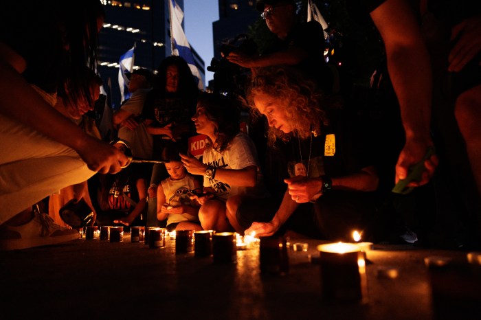 People light candles for hostages killed by Hamas, during a vigil at Columbus Circle on Sunday, Sept. 1, 2024.