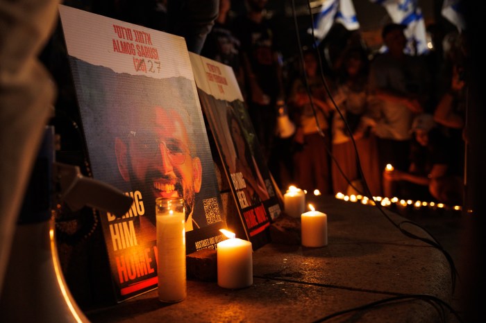 People light candles for hostages killed by Hamas, during a vigil at Columbus Circle on Sunday, Sept. 1, 2024.