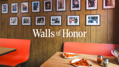 a wall in one of several NYC pizzerias that will display photos of 9/11 first responders