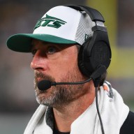 Aaron Rodgers watches the Jets' preseason game vs. the Giants from the sideline