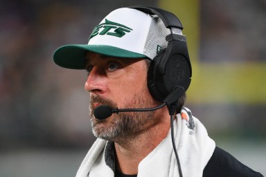 Aaron Rodgers watches the Jets' preseason game vs. the Giants from the sideline