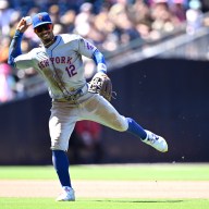 Mets SS Francisco LIndor makes a throw to 1st base