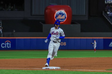 Mets DH Jesse Winker rounds third after hitting a grand slam