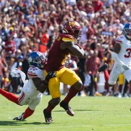 Giants Commanders Jason Pinnock tries to tackle Brian Robinson Jr.