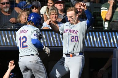 New York Mets shortstop Francisco Lindor (12) celebrates with New York Mets first base Pete Alonso (20) after hitting a home run against the Milwaukee Brewers in the sixth inning at American Family Field.