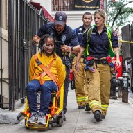 Distraught woman in tears after throwing objects off Midtown roof