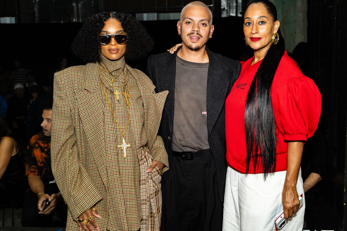 three people dressed up at New York Fashion Week.