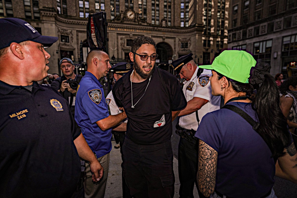 In one incident, cops quickly handcuffed a man for lighting a flare, setting off a slew of jeers at the NYPD