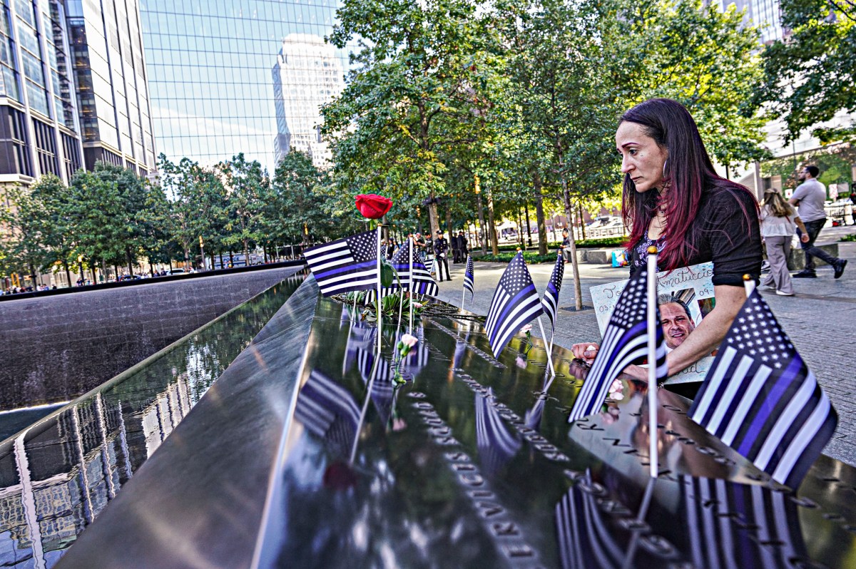 Woman at 9/11 memorial pauses to reflect on the anniversary of the terrorist attacks