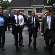 Mayor Adams walking with aides