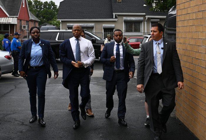 Mayor Adams walking with aides