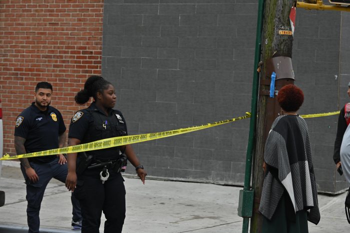 FILE - Police at a Brooklyn shooting scene