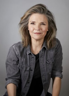 actress Kathryn Erbe wearing a gray-blue shirt