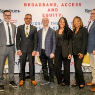 six people standing in business attire at event about the digital divide in NYC