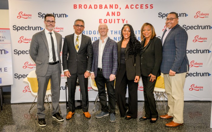 six people standing in business attire at event about the digital divide in NYC