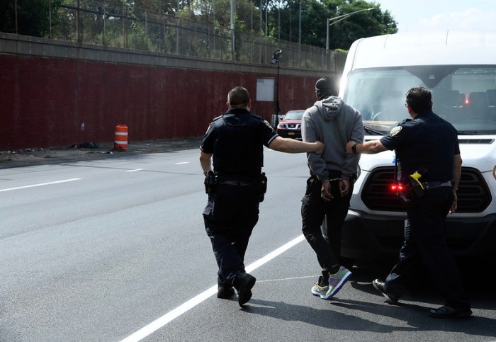 police arresting a man n NYC during a "ghost plates" operation